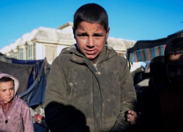 A boy displaced from his home because of drought in Kandahar province who has sought shelter in a temporary camp set up near Kandahar city. Photo: Javed Tanveer/AFP (January 2022)