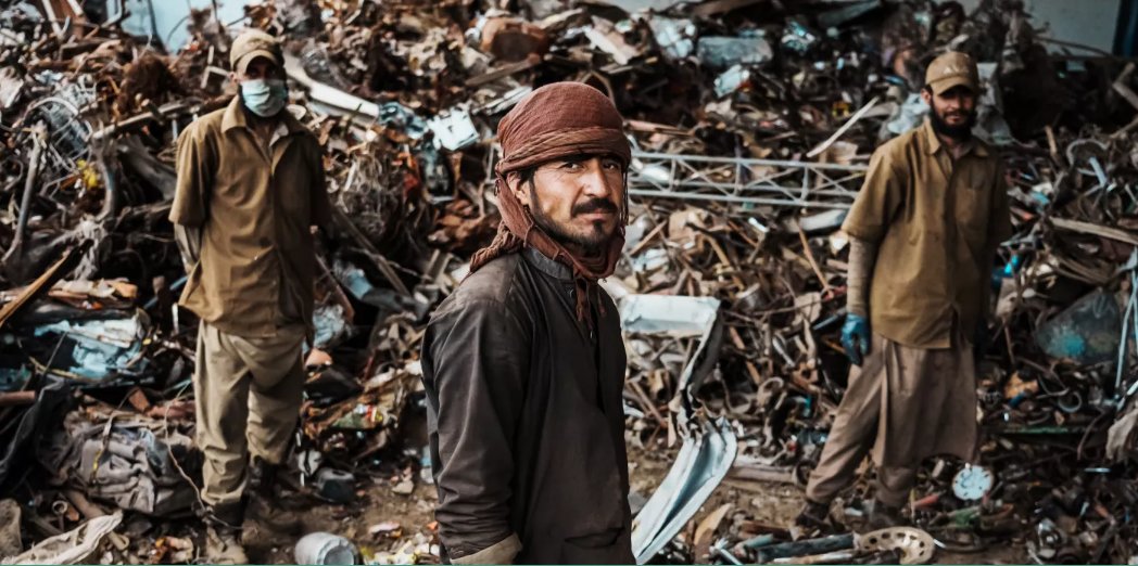 Afghan workers sort metals for recycling at a steel plant partially owned and operated by a Chinese entrepreneur in Kabul.(Marcus Yam / Los Angeles Times)