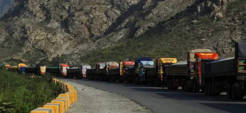 Trucks loaded with supplies park along a road leading to the Torkham border, after Pakistan closed border crossings with Afghanistan, on October 15. — Reuters